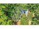 Aerial view of the house nestled in a dense, green forest at 3875 Sweetwater Dr, Cumming, GA 30041