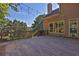 Spacious wooden back deck with string lights and railing overlooking a wooded area at 3875 Sweetwater Dr, Cumming, GA 30041