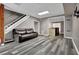 Finished basement with gray walls, recessed lighting, hard flooring, and a comfortable leather couch at 3875 Sweetwater Dr, Cumming, GA 30041