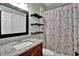 Bathroom with granite countertop vanity and a floral shower curtain at 3875 Sweetwater Dr, Cumming, GA 30041