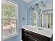 Bathroom featuring a single sink vanity and large mirror at 3875 Sweetwater Dr, Cumming, GA 30041