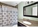 Cozy bathroom featuring a granite countertop and a shower with a patterned curtain at 3875 Sweetwater Dr, Cumming, GA 30041