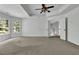The large bedroom has a tray ceiling and large bright windows at 3875 Sweetwater Dr, Cumming, GA 30041