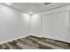 White bedroom with wood-look flooring and a closet with a double door for lots of storage at 3875 Sweetwater Dr, Cumming, GA 30041