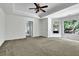 Spacious bedroom featuring tray ceiling, large window with natural light, and carpeted floor at 3875 Sweetwater Dr, Cumming, GA 30041