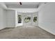 Brightly lit bedroom featuring tray ceiling and windows at 3875 Sweetwater Dr, Cumming, GA 30041