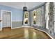 Inviting dining area featuring hardwood floors, wainscoting, and large windows with decorative curtains at 3875 Sweetwater Dr, Cumming, GA 30041