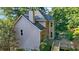A high angle view of the rear exterior of the house showing the deck and manicured landscape at 3875 Sweetwater Dr, Cumming, GA 30041