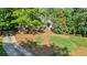 Charming home surrounded by mature trees and lush landscaping at 3875 Sweetwater Dr, Cumming, GA 30041