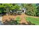 Charming home featuring a well-manicured lawn with mature trees and inviting front porch at 3875 Sweetwater Dr, Cumming, GA 30041