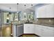 Modern kitchen with granite counters, stainless appliances, and a view to the dining area at 3875 Sweetwater Dr, Cumming, GA 30041