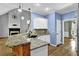Well-equipped kitchen with granite countertops, an eat-in bar, and a view into the living area at 3875 Sweetwater Dr, Cumming, GA 30041