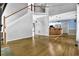 Bright living room with hardwood floors and staircase, flowing into an open kitchen with modern appliances at 3875 Sweetwater Dr, Cumming, GA 30041
