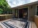Home's back deck features a table and chairs, as well as black framed glass double doors to the inside at 803 Plantation Ridge Overlook, Woodstock, GA 30188