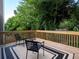 Outdoor deck with chairs, a table, and serene view of the backyard and woods at 803 Plantation Ridge Overlook, Woodstock, GA 30188