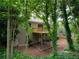 Wood-sided home with walk-out basement, upper level deck, and large backyard surrounded by mature trees at 803 Plantation Ridge Overlook, Woodstock, GA 30188