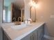 Close up of the bathroom with double vanity, stone countertops, and modern fixtures at 803 Plantation Ridge Overlook, Woodstock, GA 30188