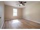 Bright bedroom features beautiful hardwood floors, a ceiling fan, and natural light at 803 Plantation Ridge Overlook, Woodstock, GA 30188