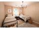 Charming bedroom featuring twin beds, stylish decor, and a sunlit window at 803 Plantation Ridge Overlook, Woodstock, GA 30188