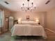 Primary bedroom features hardwood floors, a modern chandelier, and neutral paint colors at 803 Plantation Ridge Overlook, Woodstock, GA 30188