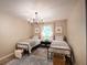 Charming bedroom featuring twin beds, stylish decor, and a sunlit window at 803 Plantation Ridge Overlook, Woodstock, GA 30188