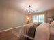 Primary bedroom boasts hardwood floors, large windows, and soft, neutral colors at 803 Plantation Ridge Overlook, Woodstock, GA 30188