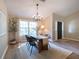 Bright dining room with a chandelier, a large window, and access to the front door at 803 Plantation Ridge Overlook, Woodstock, GA 30188