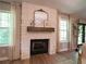 Elegant stone fireplace with a wooden mantel, perfect for cozy evenings at 803 Plantation Ridge Overlook, Woodstock, GA 30188