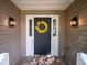 Welcoming front door with decorative wreath, sidelights, and modern lighting fixtures at 803 Plantation Ridge Overlook, Woodstock, GA 30188