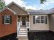Close-up of the front entrance with a cheerful wreath and stylish exterior lighting at 803 Plantation Ridge Overlook, Woodstock, GA 30188