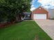 Exterior view of the home, with a brick facade, a two-car garage, and a well manicured front lawn at 803 Plantation Ridge Overlook, Woodstock, GA 30188