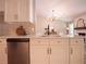 Open concept kitchen and living room with white cabinets, quartz counters, and stainless steel appliances at 803 Plantation Ridge Overlook, Woodstock, GA 30188