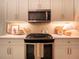 Updated kitchen features modern appliances, white cabinets, quartz counters, and custom lighting at 803 Plantation Ridge Overlook, Woodstock, GA 30188