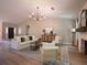 Open-concept living room with vaulted ceilings, modern lighting, and stylish furniture at 803 Plantation Ridge Overlook, Woodstock, GA 30188