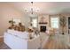 Bright living room with a stone fireplace, ample seating, and hardwood flooring at 803 Plantation Ridge Overlook, Woodstock, GA 30188