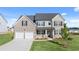 Charming two-story home featuring a two-car garage, well-manicured lawn, and welcoming front porch at 1089 Blue Juniper Cir, Loganville, GA 30052