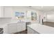 Modern kitchen with white cabinets, stainless steel appliances, and natural light at 1089 Blue Juniper Cir, Loganville, GA 30052
