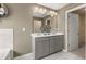Bathroom with dual sink vanity and access to the walk-in closet at 13574 Se Whitman Ln, Covington, GA 30014