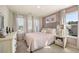 Charming bedroom featuring a bed, dresser, nightstand, and plenty of natural light from the windows at 13574 Se Whitman Ln, Covington, GA 30014