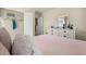 Comfortable bedroom with dresser, open closet with door, and view into other rooms at 13574 Se Whitman Ln, Covington, GA 30014
