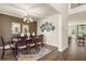 Elegant dining room featuring hardwood floors, decorative lighting, and stylish decor at 13574 Se Whitman Ln, Covington, GA 30014