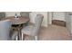 Close-up of dining room table and chairs with gray fabric, plus white trim and doorway at 13574 Se Whitman Ln, Covington, GA 30014
