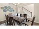 Spacious dining room with modern décor, hardwood floors, and ample natural light at 13574 Se Whitman Ln, Covington, GA 30014