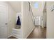 Bright foyer featuring a hardwood floor, coatrack, and white front door at 13574 Se Whitman Ln, Covington, GA 30014