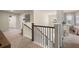 Hallway with staircase, art on the walls, and view into another room with nice chandelier at 13574 Se Whitman Ln, Covington, GA 30014