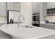 Bright, open kitchen with stainless steel appliances and a large island at 13574 Se Whitman Ln, Covington, GA 30014