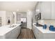 Stylish kitchen featuring gray cabinets, stainless steel appliances, and a central island with a sink at 13574 Se Whitman Ln, Covington, GA 30014