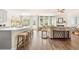 Open-concept kitchen and living room with fireplace, hardwood floors, and natural light at 13574 Se Whitman Ln, Covington, GA 30014