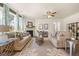 Comfortable living room with plush sofas, fireplace, and large windows providing ample natural light at 13574 Se Whitman Ln, Covington, GA 30014
