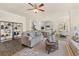 Spacious living room featuring modern decor, an open layout, and seamless access to the kitchen at 13574 Se Whitman Ln, Covington, GA 30014